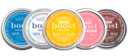 Boost Gummies – assorted THC and CBD edibles in labelled tins with flavours like sour lemon, cola and blue raspberry