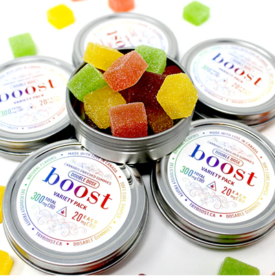 Boost Cannabis Edibles – variety pack of THC and CBD gummies in tins with colourful cube-shaped fruit flavours